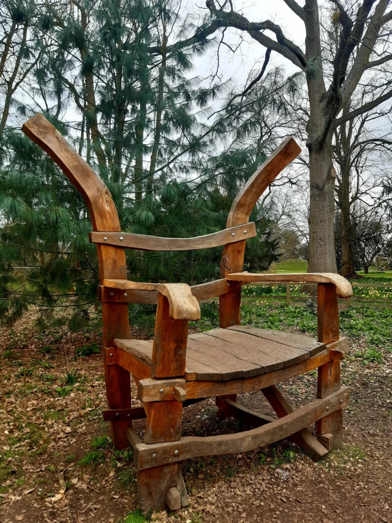 An oversized wooden chair, in Knebworth's Wilderness Garden, for children and families to sit on for a fun autumnal photo opportunity.